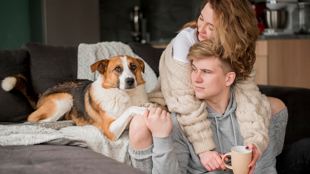 Couple with dog hugging