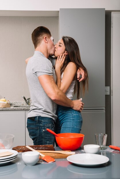 Couple with flour on faces kissing 