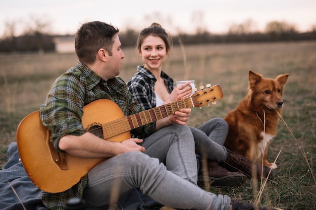 Couple with guitar and cute dog