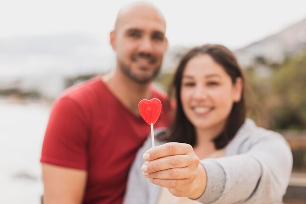 Couple with heart lollipop