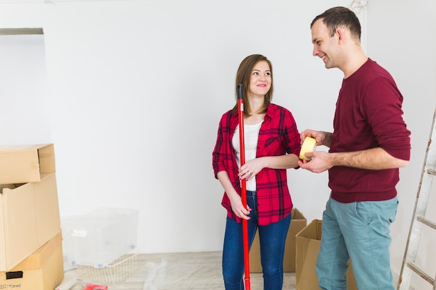 Free photo couple with renovation tools looking at each other