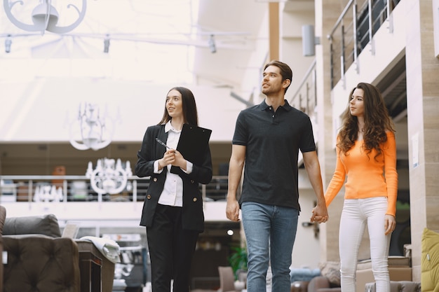 Couple with salesman in furniture store