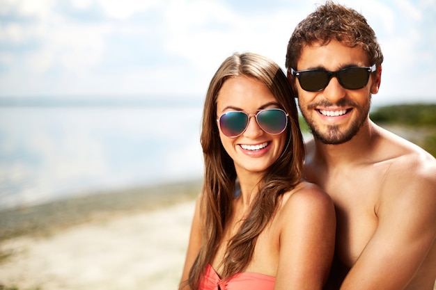 Couple with sunglasses on the beach