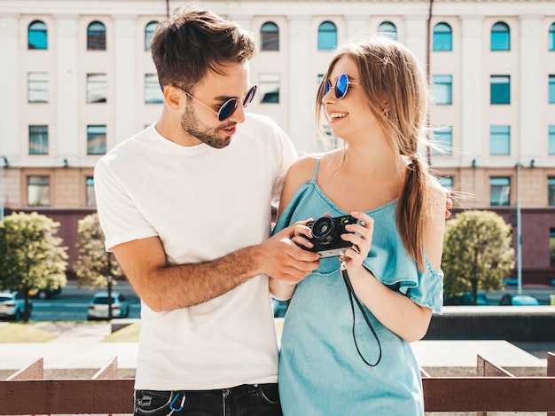 Couple with sunglasses posing in the street