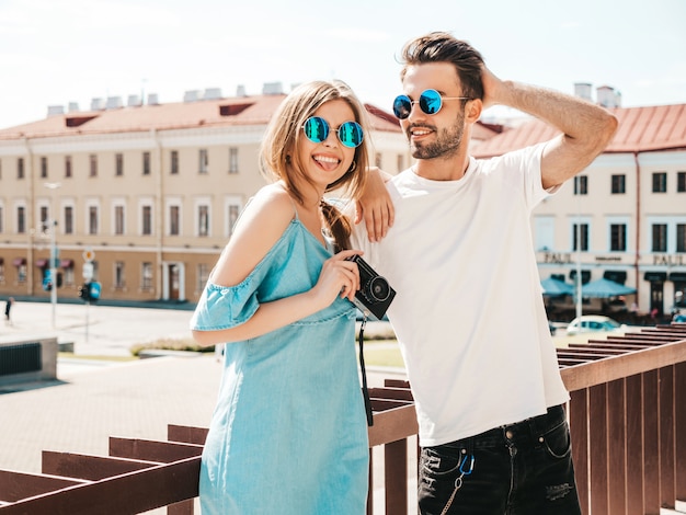 Couple with sunglasses posing in the street