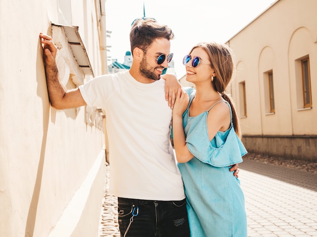 Couple with sunglasses posing in the street