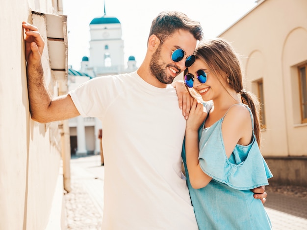 Couple with sunglasses posing in the street