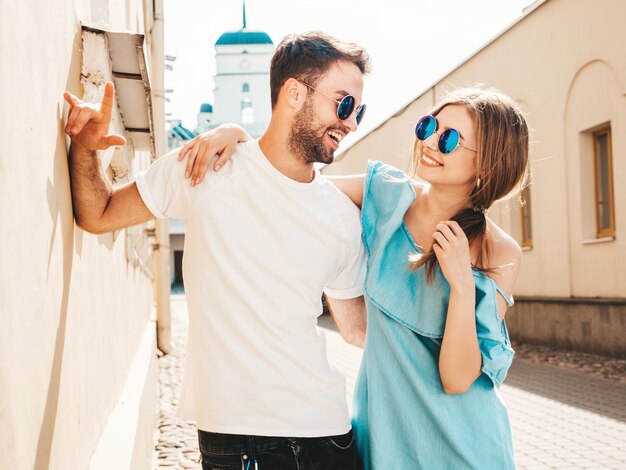 Couple with sunglasses posing in the street