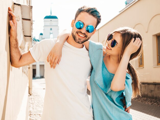 Couple with sunglasses posing in the street