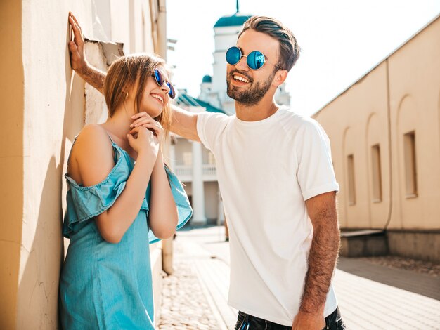 Couple with sunglasses posing in the street