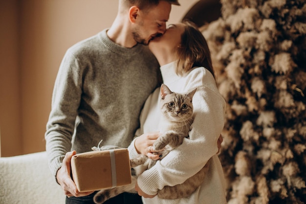 Free Photo couple with their kitten celebrating christmas