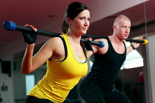 Couple working out in a fitness gym