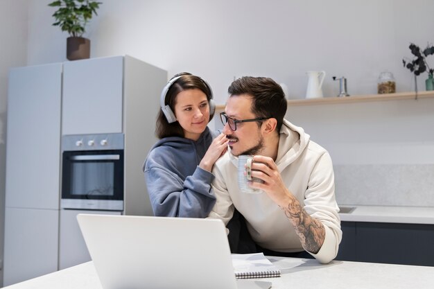 Couple working together from home kitchen