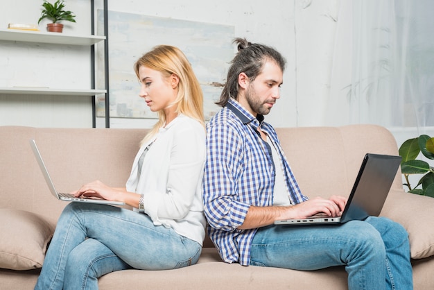 Couple working with laptops