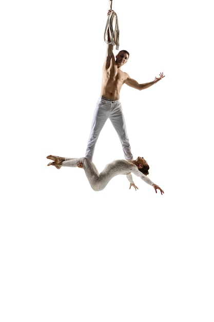 Free photo couple of young acrobats, circus athletes isolated on white.