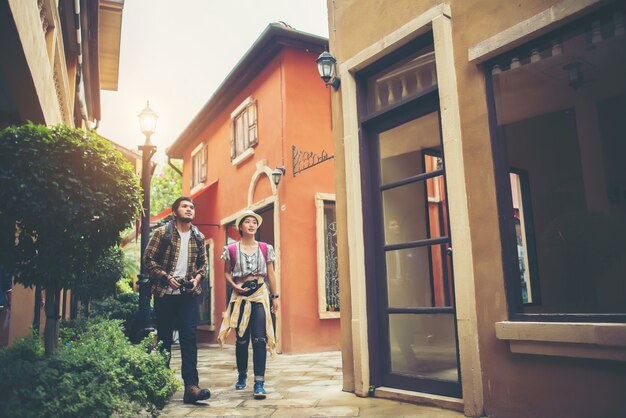 Couple of young tourists walking in urban enjoy holiday together. Couple travel concept.