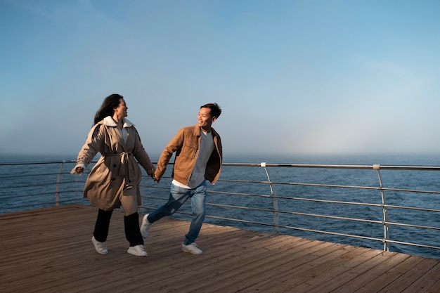 Free photo couples embracing near the sea