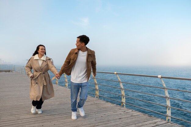 Free Photo couples embracing near the sea