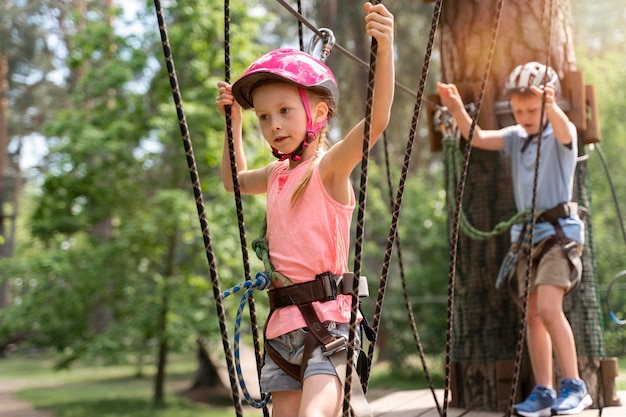 Courageous children having fun at an adventure park