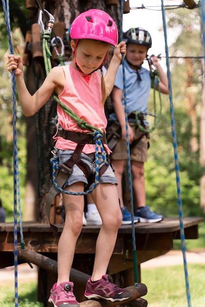 Courageous kids having fun at an adventure park