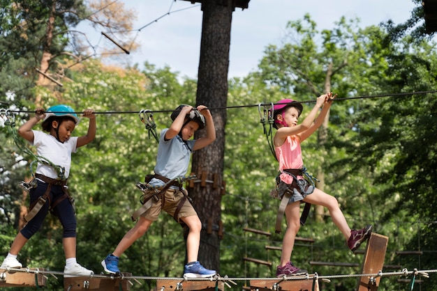 Free photo courageous kids playing in an adventure park