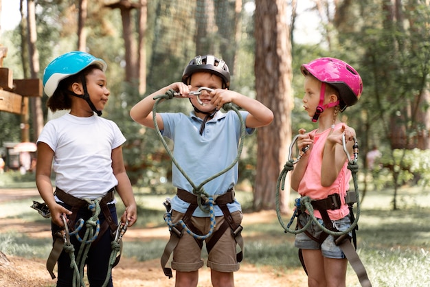 Free photo courageous kids playing in an adventure park