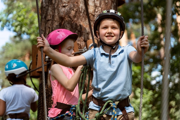 Free photo courageous kids playing in an adventure park