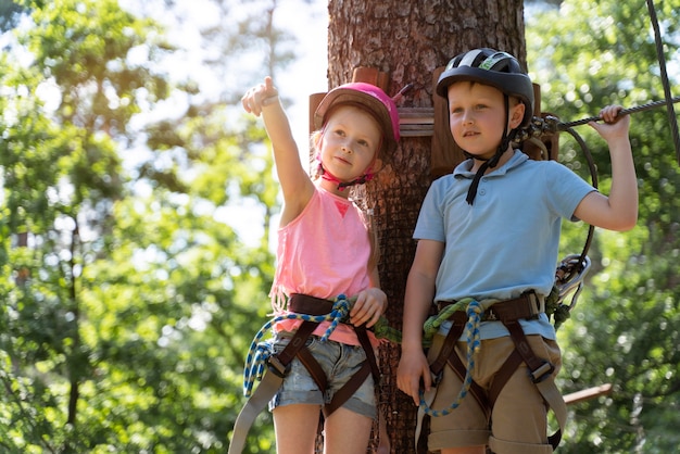 Free photo courageous kids playing in an adventure park