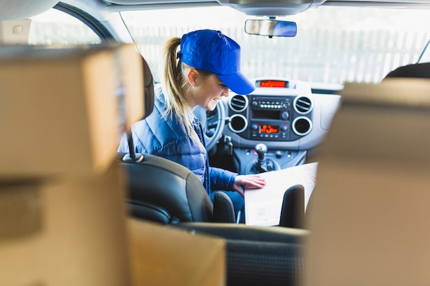 Courier girl sitting in car