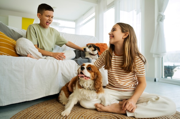 Cousins spending time together at home with pet dog