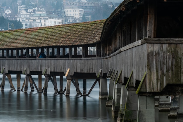 Free photo covered bridge near the lucerne jesuit church surrounded by buildings in lucerne in switzerland