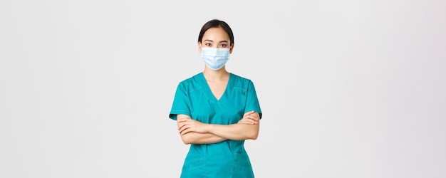 Free Photo covid coronavirus disease healthcare workers concept smiling confident asian female doctor physician...