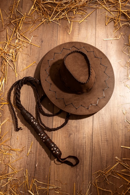 Free photo cowboy inspiration with hat on wooden floor