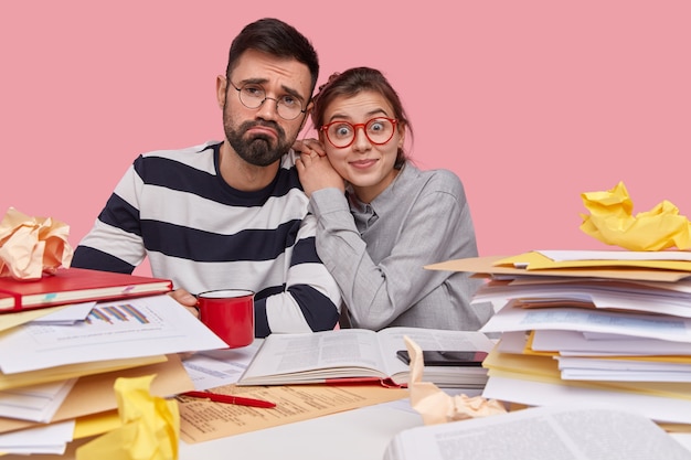 Coworkers sitting at desk with documents