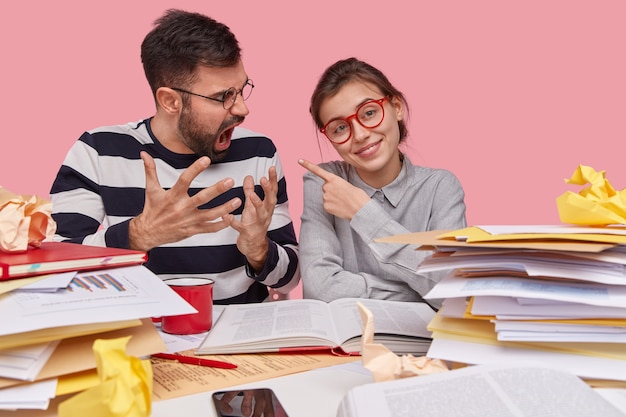 Coworkers sitting at desk with documents