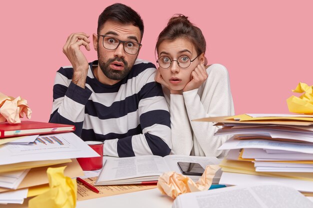 Coworkers sitting at desk with documents