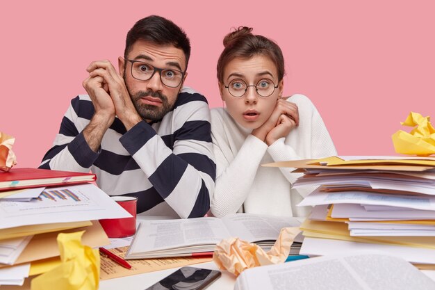 Coworkers sitting at desk with documents