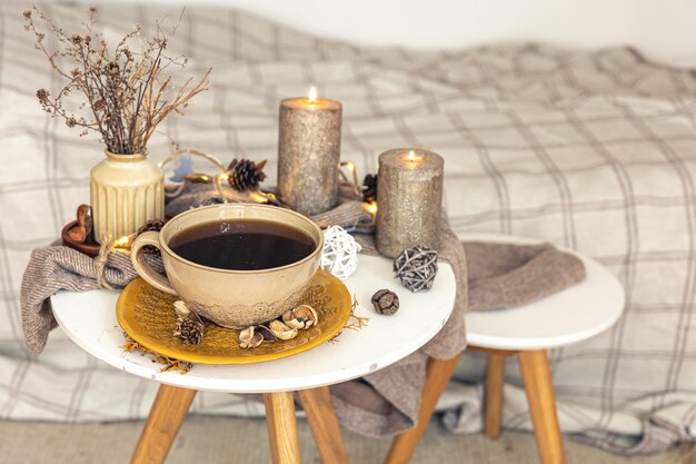 Cozy autumn composition with a cup of tea and decorative details