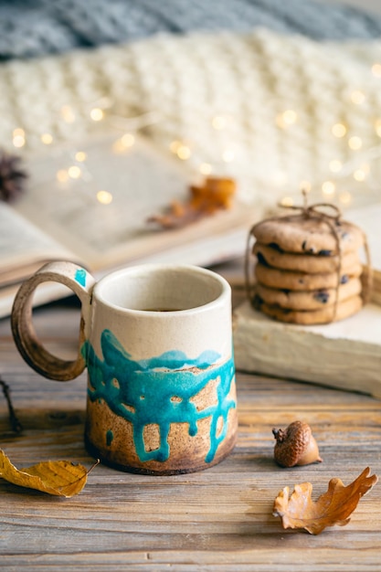 Free photo cozy autumn composition with a handmade cup closeup