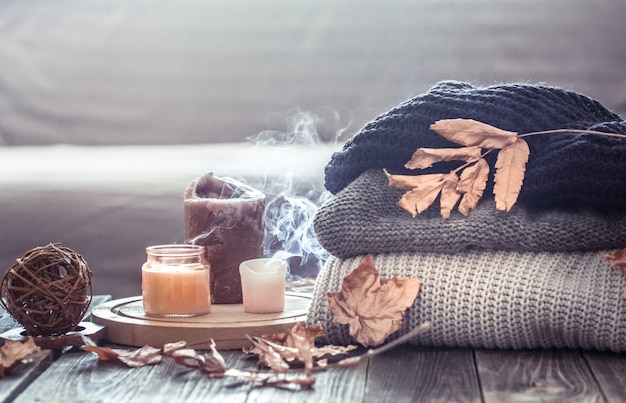 Cozy autumn still life with candles and a sweater