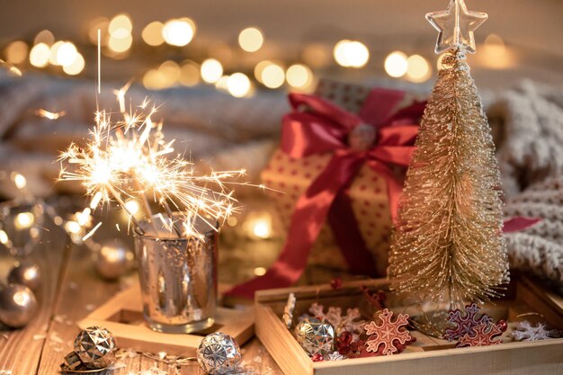 Cozy christmas background with glowing sparklers and decor details