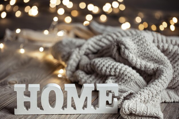 Cozy composition with a decorative word home and knitted element