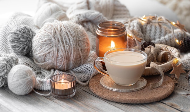 Free Photo a cozy composition with threads a candle and a cup of coffee hobby and home comfort concept