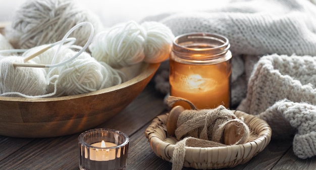 Free photo a cozy composition with threads a candle hobby and home comfort concept