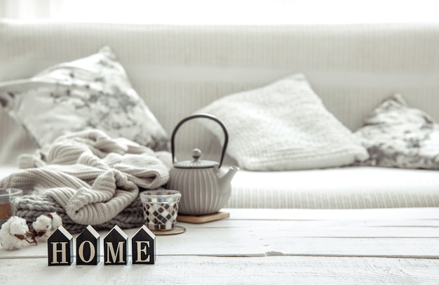 Free photo cozy home composition with a teapot, knitted items and scandinavian decor details