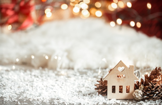 Cozy winter christmas background with bokeh and wooden decor details on a light background.