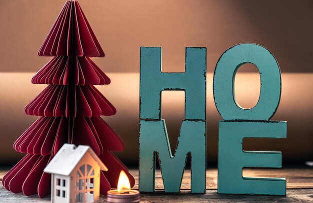 Cozy winter composition with decorative word home and paper christmas tree