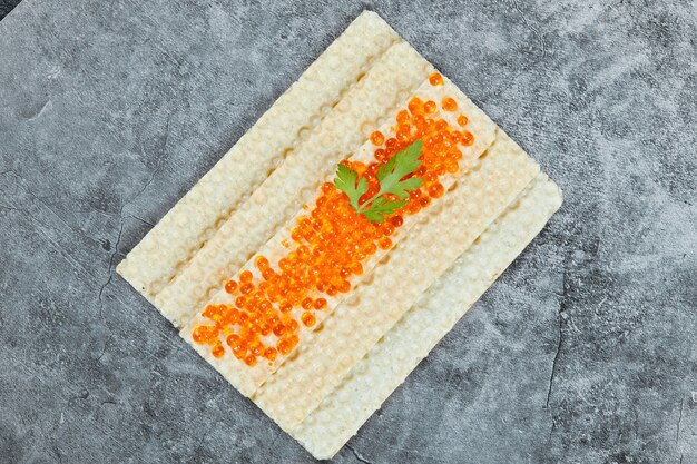 Cracker with red caviar.