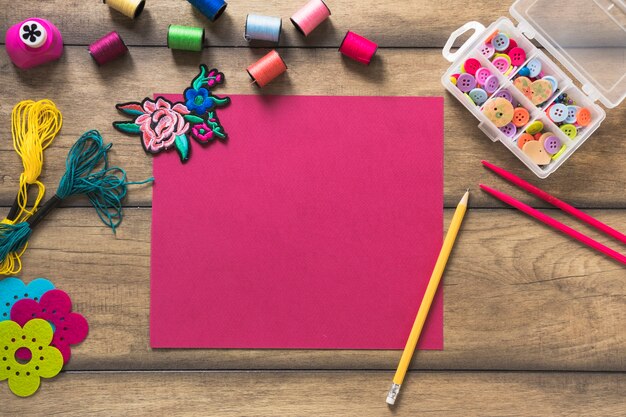 Craft items and blank decorative card on wooden backdrop