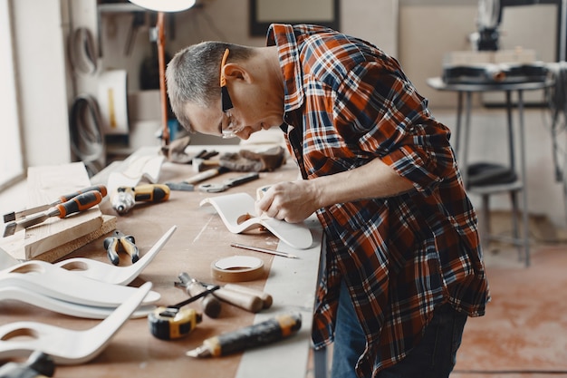 Craftsman cutting a wooden plank